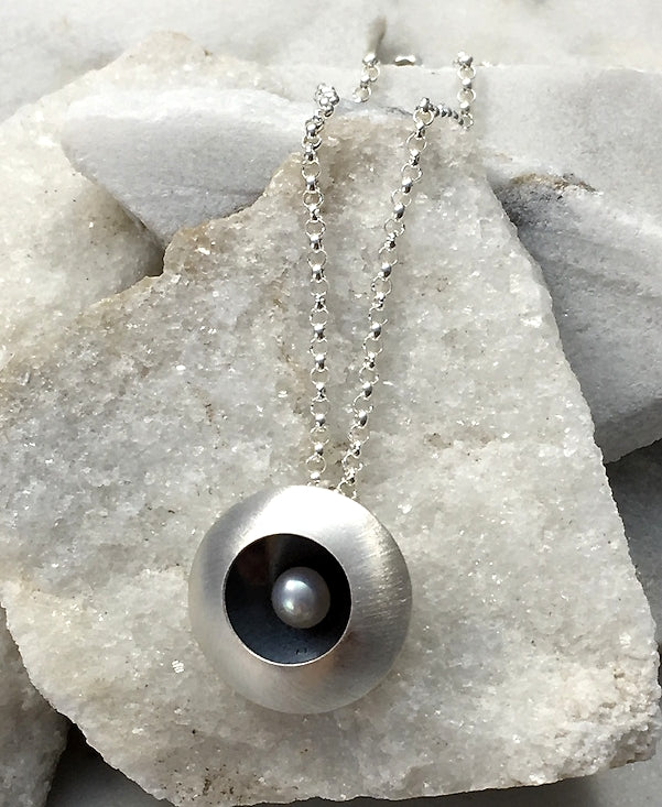 EMMA TALLACK JEWELRY —  Handcrafted Double-Domed, Brushed Sterling Silver and White Button Pearl Pendant / Necklace with Oxidized Center — 1.5 centimeters